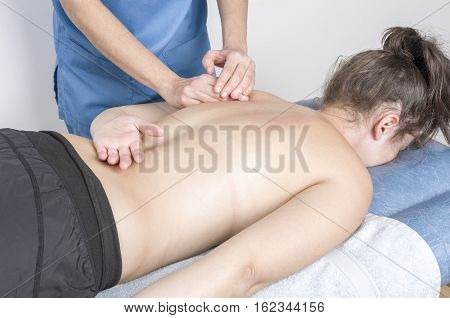 Physiotherapist, Chiropractor Giving A Massage And Stretching Of Subscapularis And Rhomboid
