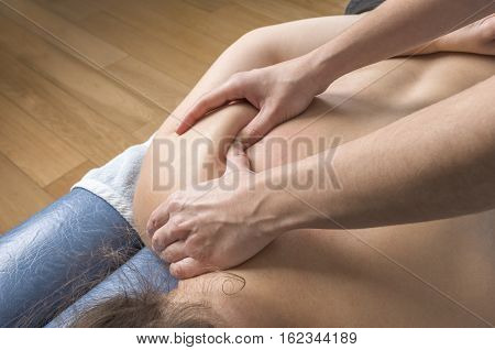 Physiotherapist, Chiropractor Giving A Massage And Stretching Of Subscapularis And Rhomboid