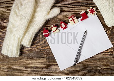 Christmas banner. Letter to Santa Claus. Wish list. Winter background. Hands in mittens.