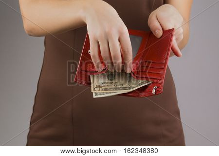 purse with money in the hands of women spending money