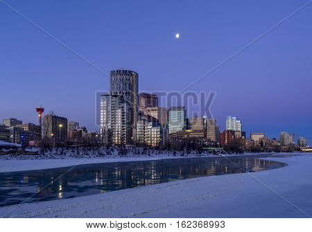 CALGARY, CANADA - DEC 17: Calgary's skyline at sunrise on a cold winter day on December 17, 2016 in Calgary, Alberta. Calgary is home to many oil companies. The Bow River is visible.