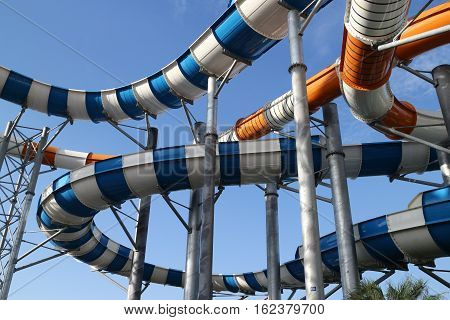 Slider in swimming pool and sky background