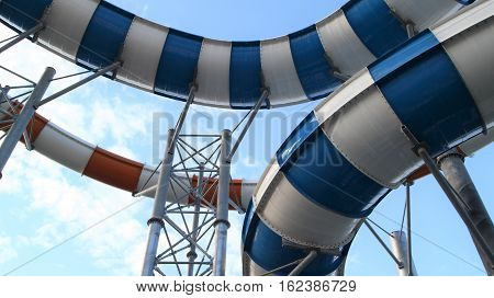 Slider in swimming pool and sky background