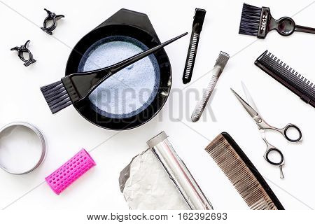 Tools for hair dye and hairdye top view on white background