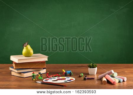 Back to school concepty with clear blackboard background, desk, items