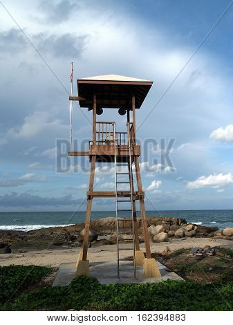 lifeguard warning tower on the beach and blue sky with cloudy over the sea, wooden buildings for announce and alert to tourists, vertical image