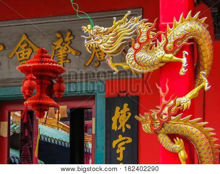 KUALA LUMPUR, MALAYSIA - JANUARY 11, 2014: Golden dragon at an entrance to the GuanDi Temple. Chinatown, Kuala Lumpur, Malaysia