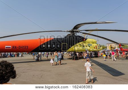 Tyumen, Russia - August 11, 2012: Air show On a visit at UTair in heliport Plehanovo. People explore the MI-10K helicopter