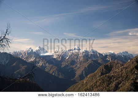 Julian Alps mountain view of snow-cover mountains on a sunny day in winter time.