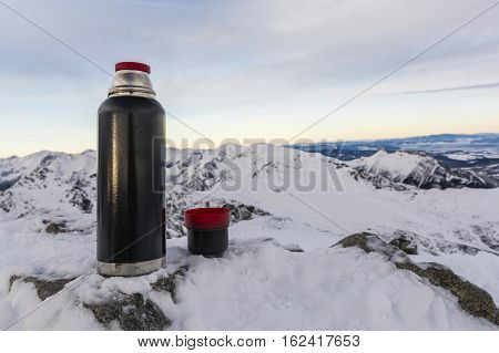 Cup Of Tea And A Thermos On A Background Of Mountains.