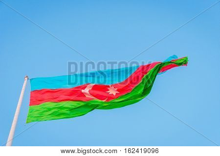 Azeri flag waving in wind at National flag square Baku Azerbaijan