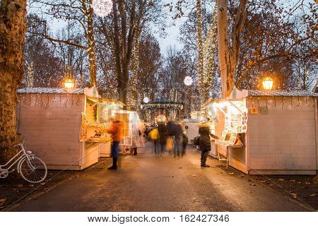Advent time in the center of Zagreb, Croatia, people gathering in Zrinjevac park with food stands, blurred motion, unrecognizable people