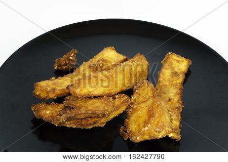 Thai snack Fried potatoes on black plate.jpg