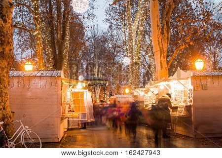 Advent time in the center of Zagreb, Croatia, people gathering in Zrinjevac park with food stands, blurred motion, unrecognizable people