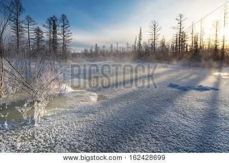 ice crust on the creek frosty sunny morning in South Yakutia Russia