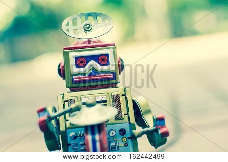 Old robot toy, vintage color style, vintage tone background.