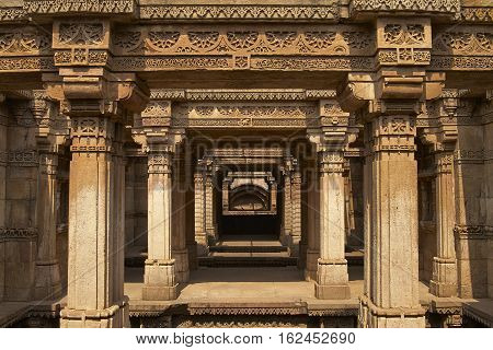 AHMADABAD, INDIA - OCTOBER 30, 2007: Ornately carved stonework of the Adalaj Stepwell on the outskirts of Ahmadabad, Gujarat, India. Built circa 1499.