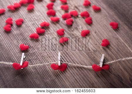 Red textile hearts connected by clothespin. Love concept