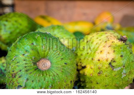 Soursop fruit at asian market or Annona muricata in assortment on sale