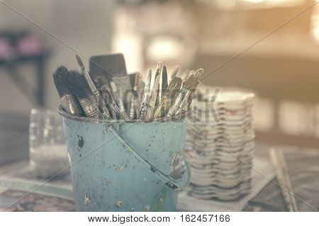 Artist Paintbrushes In Dirty Bucket.
