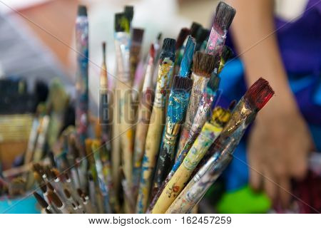 Artist Paintbrushes In Dirty Bucket.