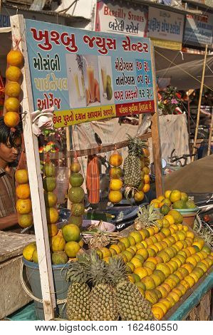 AHMADABAD, INDIA - OCTOBER 31, 2007: Man selling fruit juice from a cart at a street market in Ahmadabad, Gujarat, India