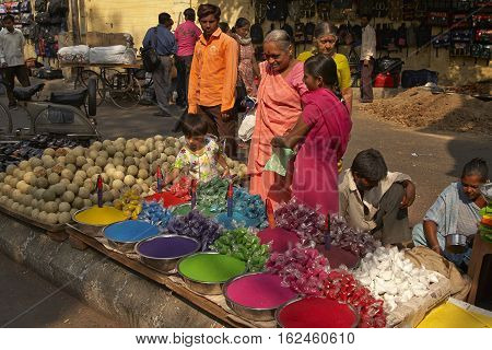 AHMADABAD, INDIA - OCTOBER 30, 2007: Street market with women selling colorful paint powder for the Hindu festival of Holi in Ahmadabad, Gujarat, India