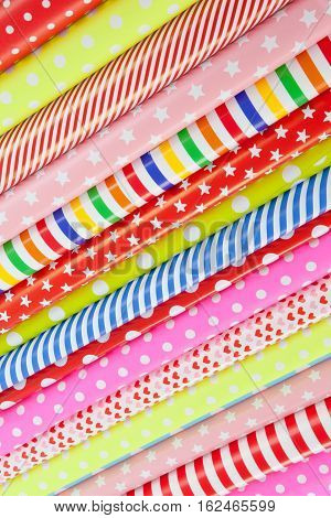 Cheerful background made from rolls of colorful wrapping paper