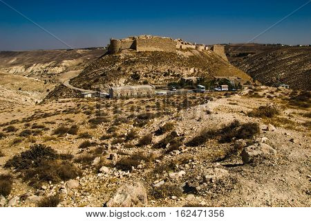 Photo of the Remains ancient impressive castle on mountain. Shobak crusader fortress. Castle walls. Travel concept. Jordan architecture and attraction