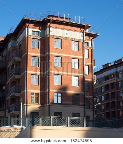 story house with windows, against the blue sky