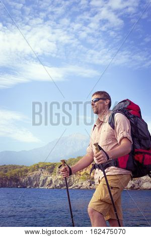 Summer hiking in the mountains with a backpack .