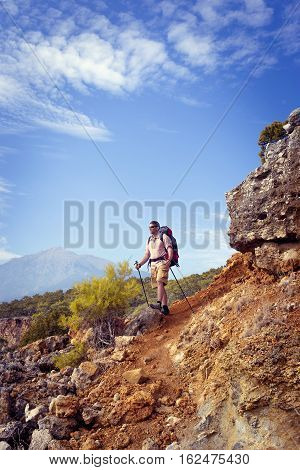 Summer hiking in the mountains with a backpack .