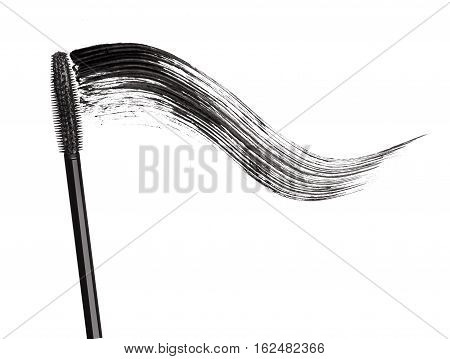 Stroke of black mascara with applicator brush close-up isolated on white background
