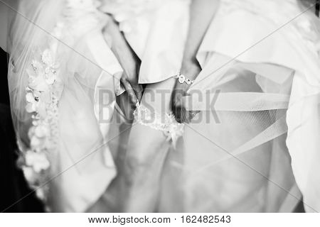 Graceful leg with a garter enveloped in tulle