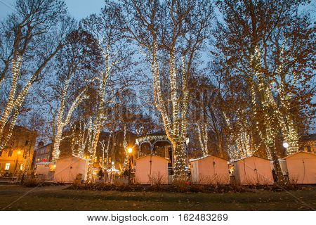 Advent time in the center of Zagreb, Croatia, decorated trees and stands in park Zrinjevac