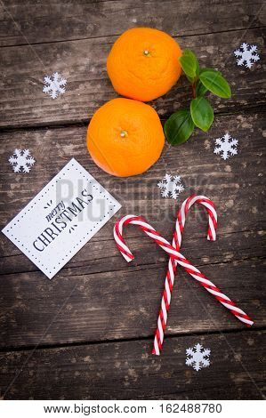 Holiday Card with Tangerines Decorated as Fir-tree Toy. Branch of Coniferous on White Snow