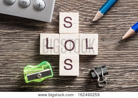 Crossword collected of cubes and spelling word SOS and LOL