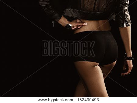 Sexy ass in black shorts in black background