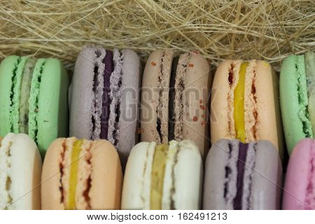 French multicolored cake macaron in a straw box a delicious dessert gift holiday