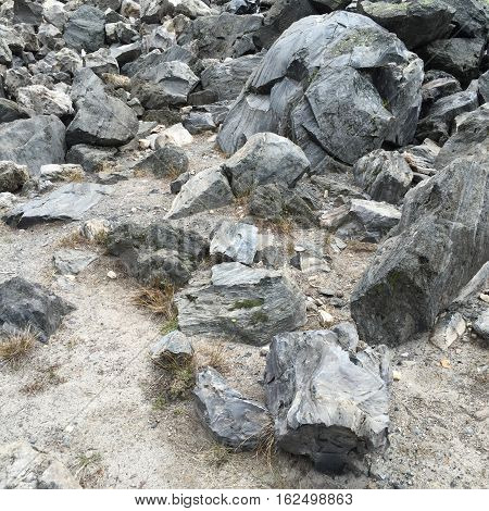 Large boulders of obsidian on the Big Obsidian Flow in the Newberry National Volcanic Monument in Central Oregon on a spring day.