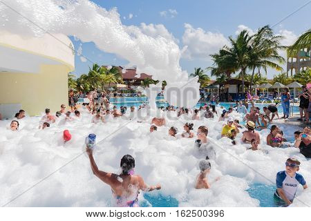 Cayo Coco island, Memories Carib hotel, July 2, 2016, amazing beautiful, gorgeous view of happy smiling joyful people relaxing and enjoying their time in swimming pool foam party on sunny day