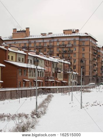 beautiful winter view of the house and terraced houses, snow-covered streets