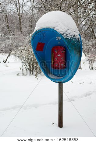old broken pay phone, in the snow