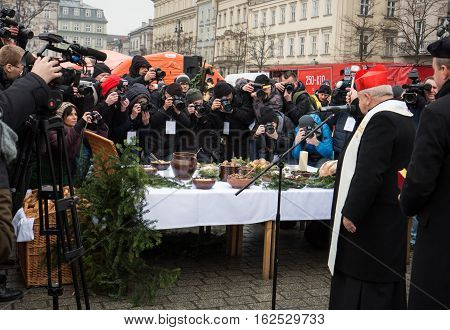 CRACOW POLAND - DECEMBER 18 2016: Christmas Eve for poor and homeless on the Central Market in Cracow. Every year the group Kosciuszko prepares the greatest eve in the open air in Poland