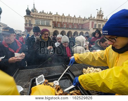 CRACOW POLAND - DECEMBER 18 2016: Christmas Eve for poor and homeless on the Central Market in Cracow. Every year the group Kosciuszko prepares the greatest eve in the open air in Poland