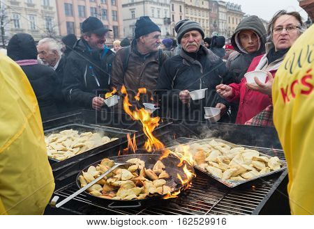 CRACOW POLAND - DECEMBER 18 2016: Christmas Eve for poor and homeless on the Central Market in Cracow. Every year the group Kosciuszko prepares the greatest eve in the open air in Poland