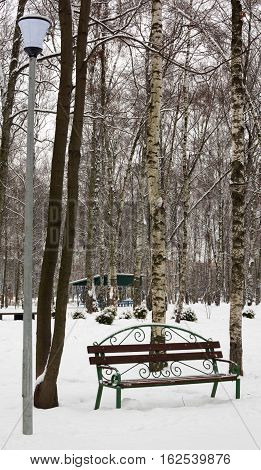 lonely bench in a frozen snowy park