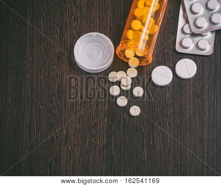 Top view of medicine Pills and tablets or drugs  with orange pill bottle for healthcare. medical help concept. copyspace for text