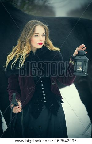 Girl In Dark Clothes With A Black Horse