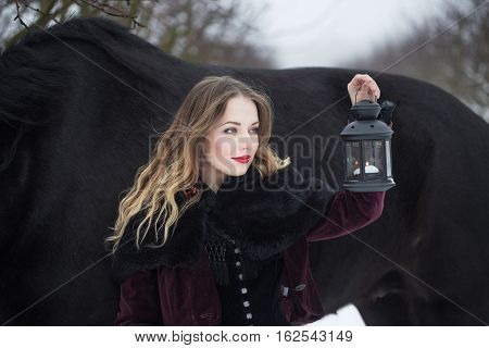 Girl In Dark Clothes With A Black Horse